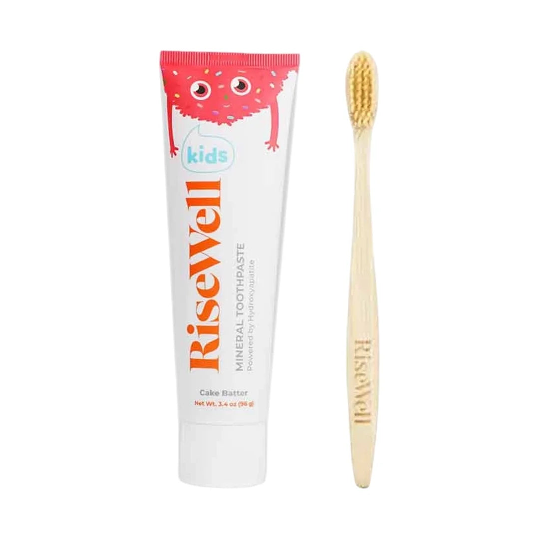 RiseWell kids toothpaste in Cake Batter flavor with wooden toothbrush, containing mineral toothpaste and fluoride.