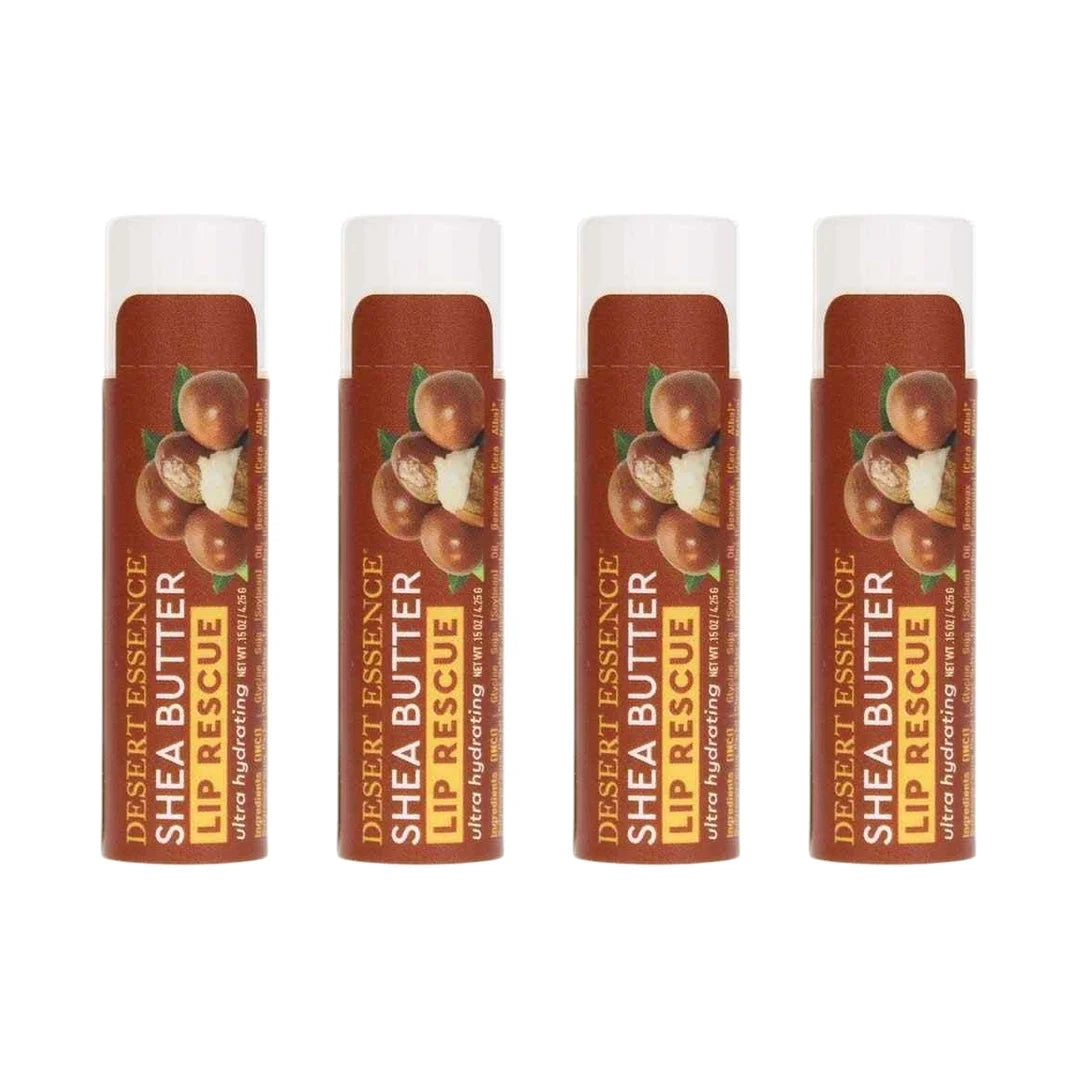 Four brown and white Desert Essence Shea Butter Lip Rescue tubes with peach imagery on burgundy labels.