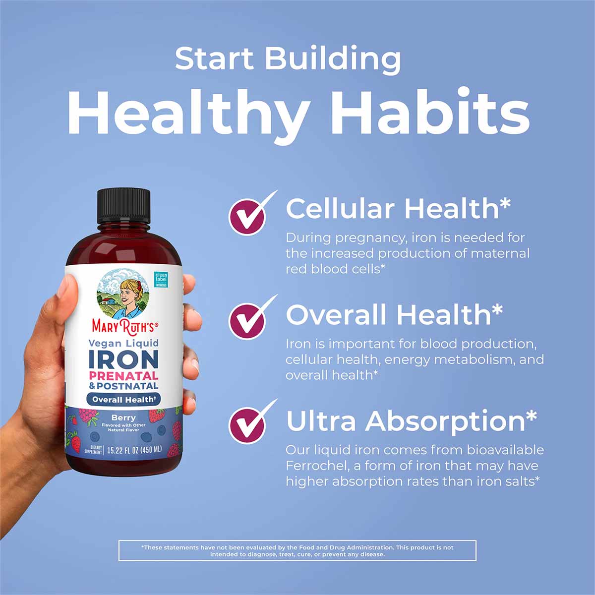 Hand holding dark amber bottle of MaryRuth's vegan liquid iron supplement with black cap and berry-flavored label against blu