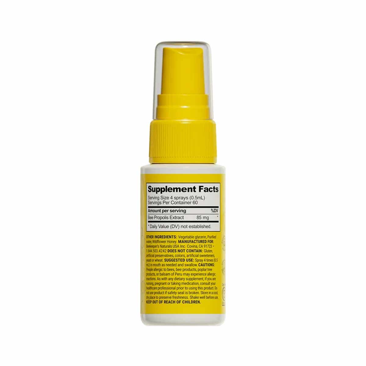Yellow and white spray bottle of propolis throat spray with yellow pump nozzle and supplement facts label.