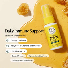Yellow throat spray bottle with yellow pump top and white label on golden background with honeycomb pieces.