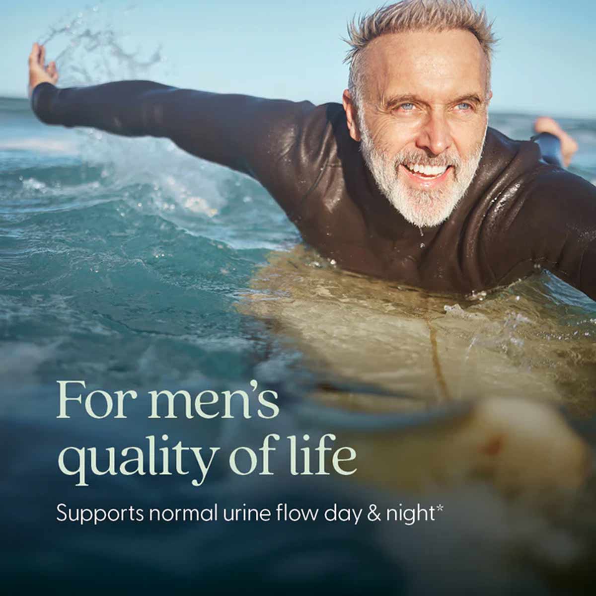 Older man in black wetsuit in ocean water with text "For men's quality of life" and "Supports normal urine flow day & night."