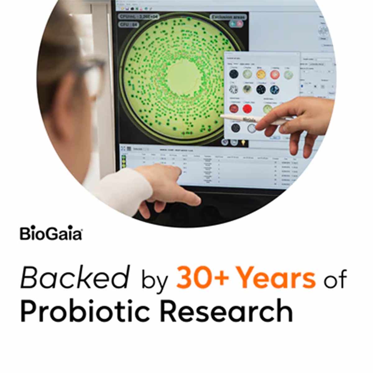 Hands pointing at a computer screen displaying green bacterial colony analysis with BioGaia logo.