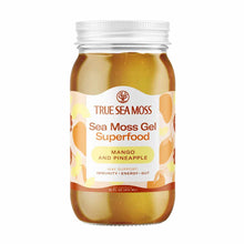 Glass jar of True Sea Moss brand golden-brown sea moss gel with mango and pineapple flavor label, 16 fl oz size.