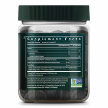 Clear glass jar with green cap containing dark gray-black gummies and supplement facts label.