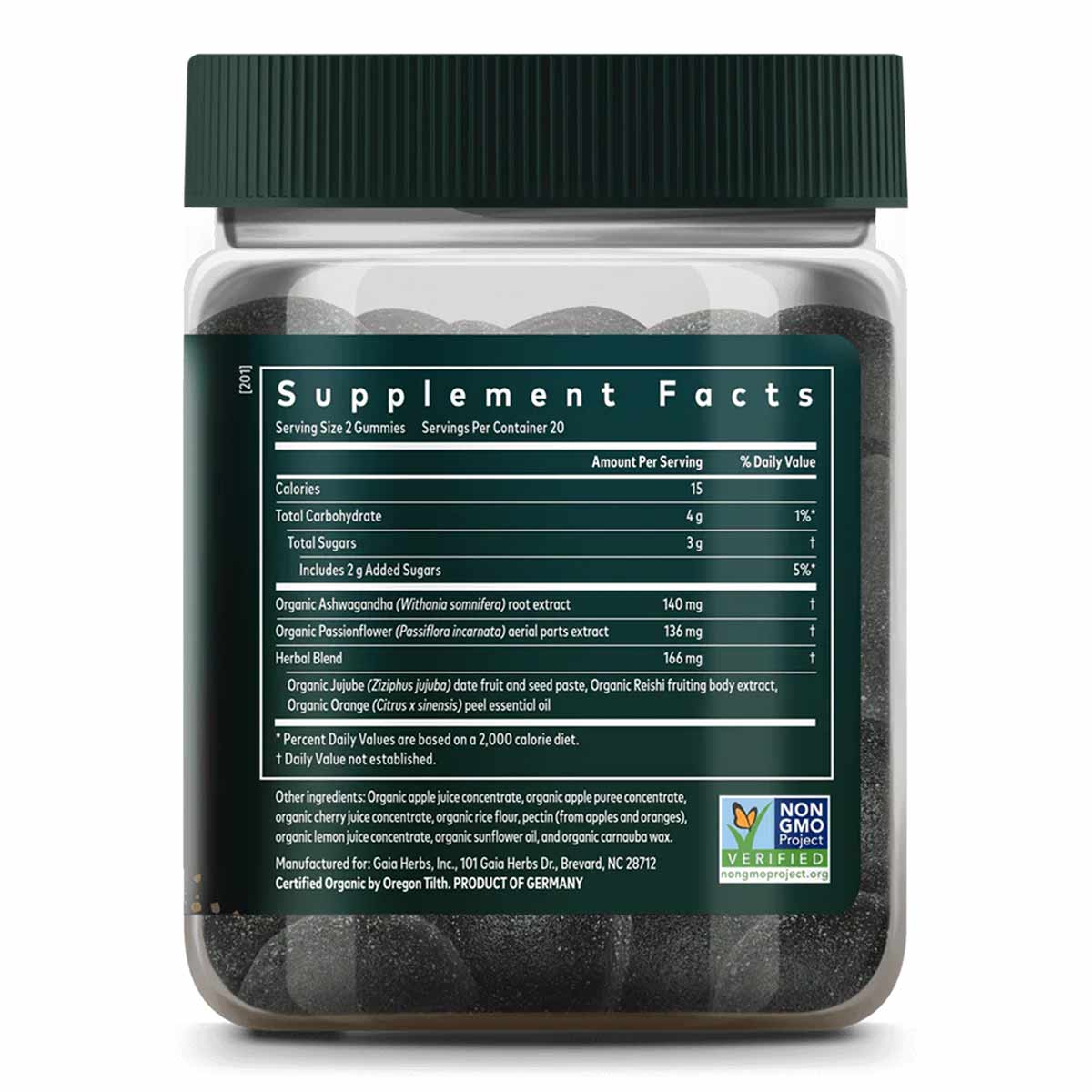Clear glass jar with green cap containing dark gray-black gummies and supplement facts label.