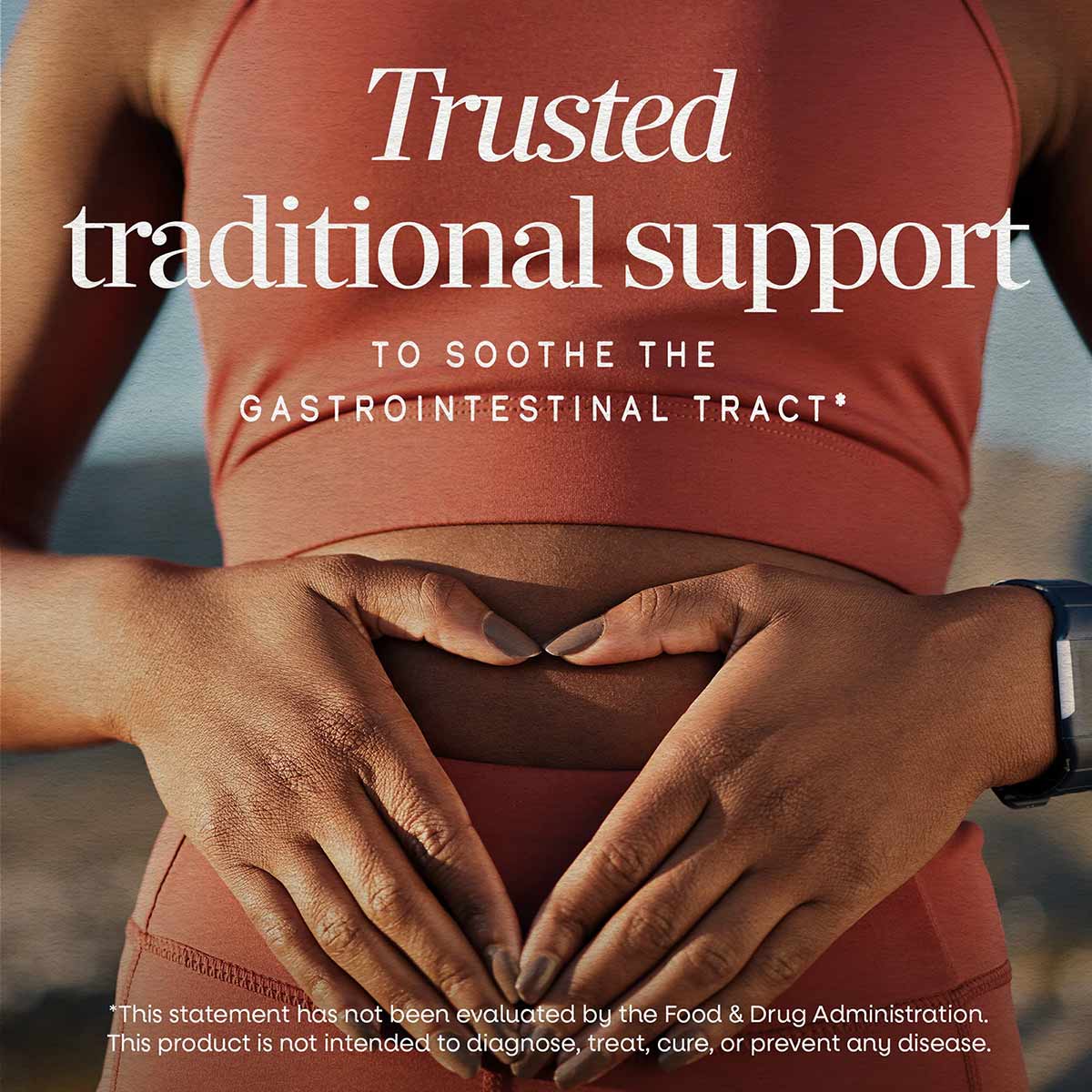 Person wearing coral shirt with hands placed on abdomen, text overlay reads "Trusted traditional support to soothe the gastro