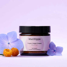 Mad Hippie Triple C Night Cream in amber glass jar with black lid, surrounded by purple flowers and orange berries on lavende