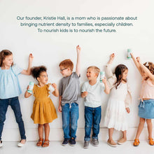 Six children of varying ages holding mint-colored vitamin bottles against a white wall.