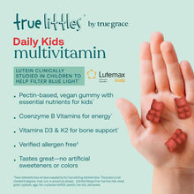 True Littles Daily Kids Multivitamin gummy bears displayed in child's hands against light blue background.