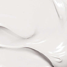 Creamy white lotion with smooth, glossy texture swirled against a neutral background.