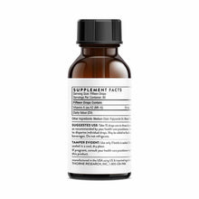 Amber glass bottle with black cap and white label showing supplement facts for Vitamin K2 liquid.