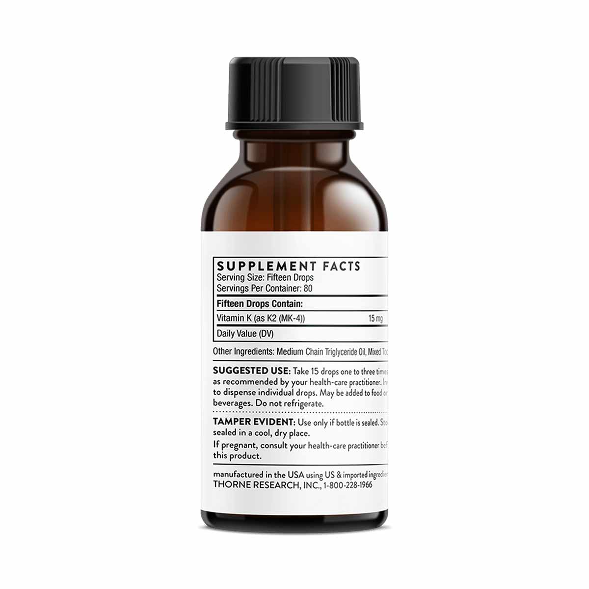 Amber glass bottle with black cap and white label showing supplement facts for Vitamin K2 liquid.
