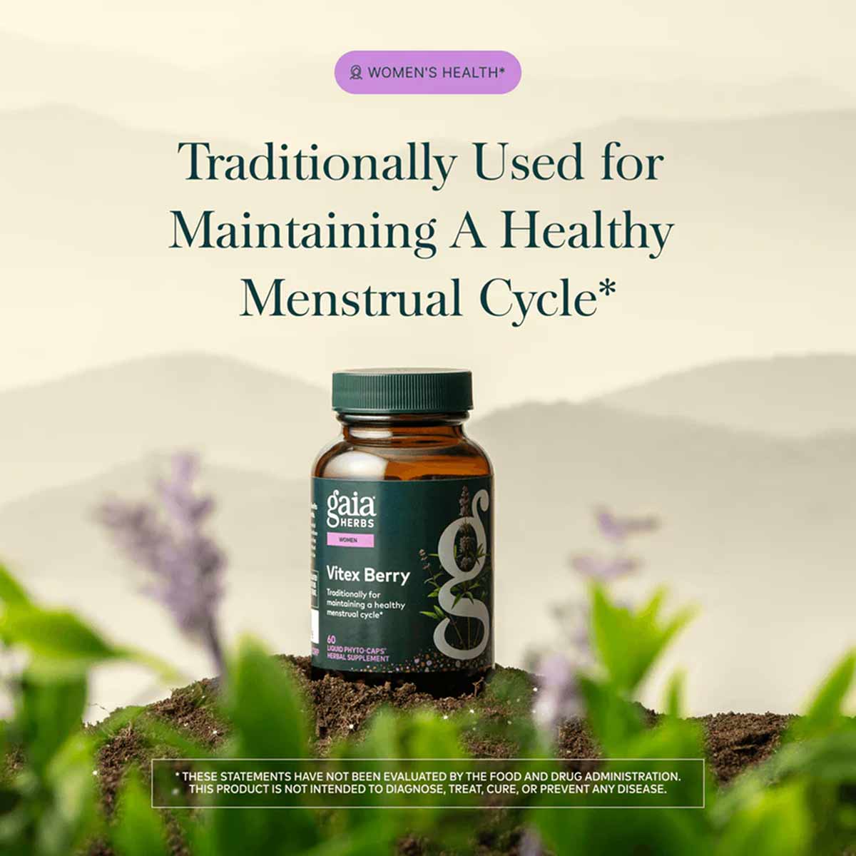 Gaia Herbs Vitex Berry supplement bottle with green cap on soil, surrounded by purple flowers and green foliage.