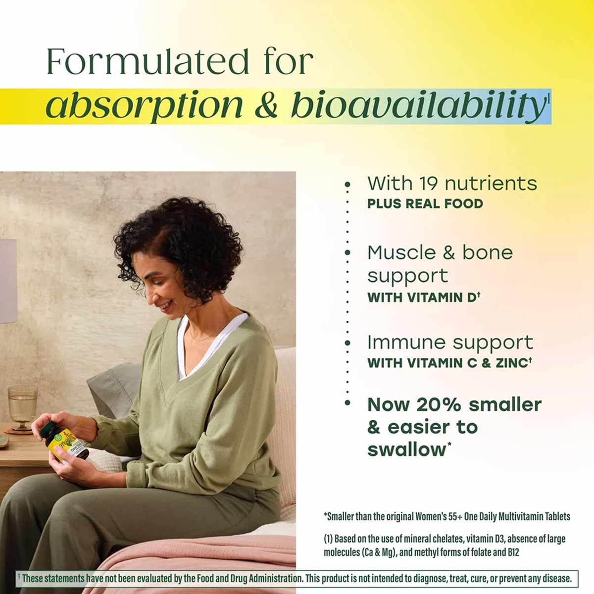 Woman holding a yellow Megafood Women's 55+ One Daily Multivitamin bottle while seated indoors.