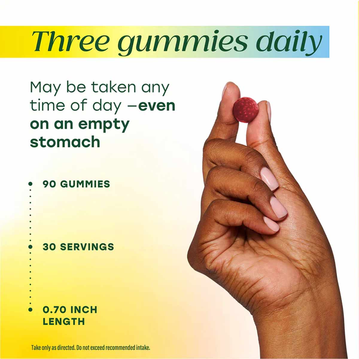 Hand holding three red and pink gummy vitamins with product details including 90 gummies, 30 servings, and 0.70 inch length.